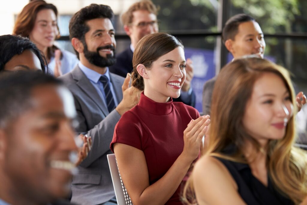 Audience applauding at a business seminar, close up